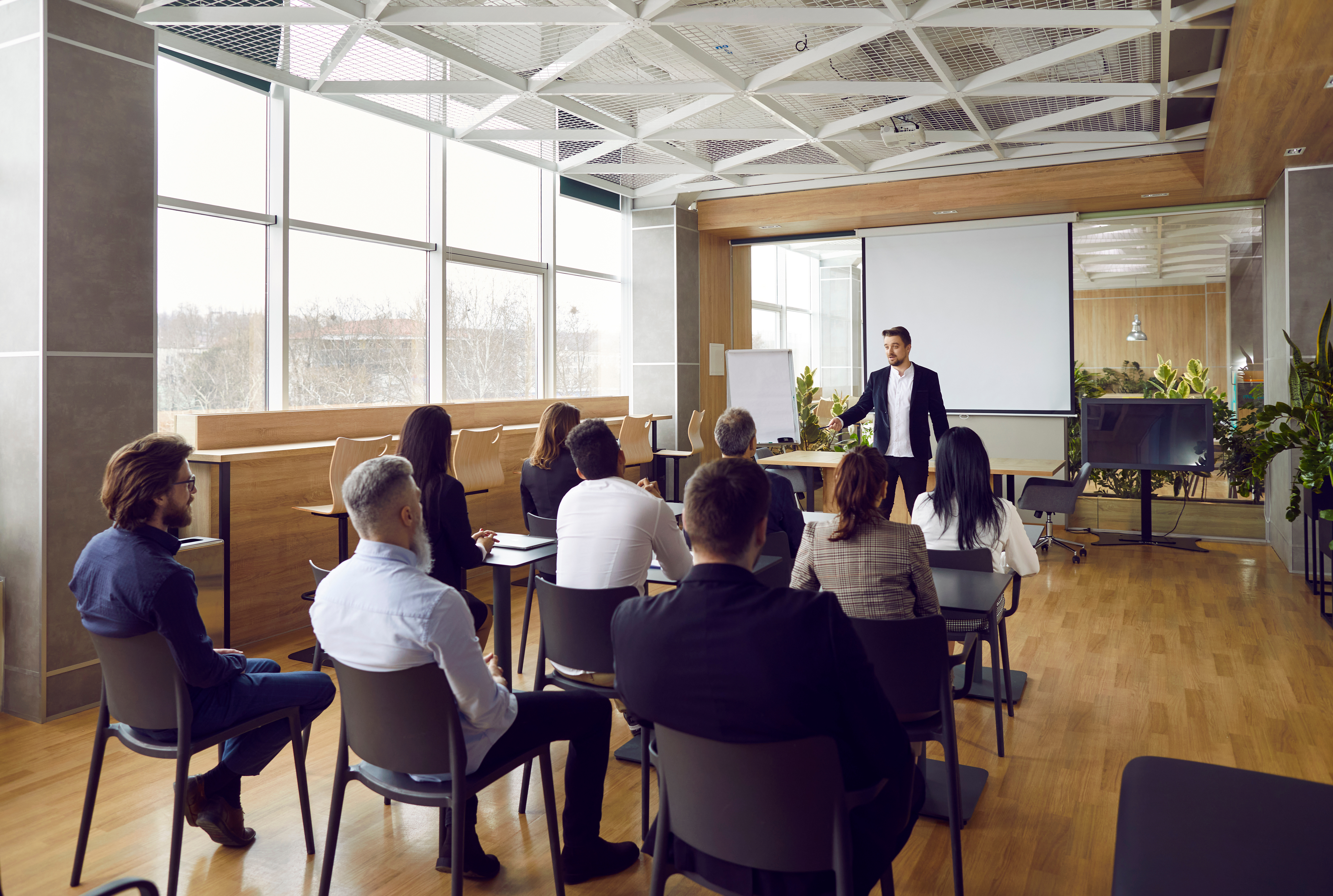 Room full of professionals watching a lecture
