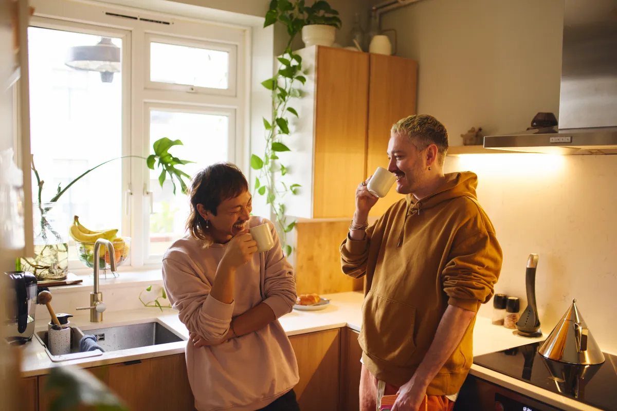 two people standing in kitchen